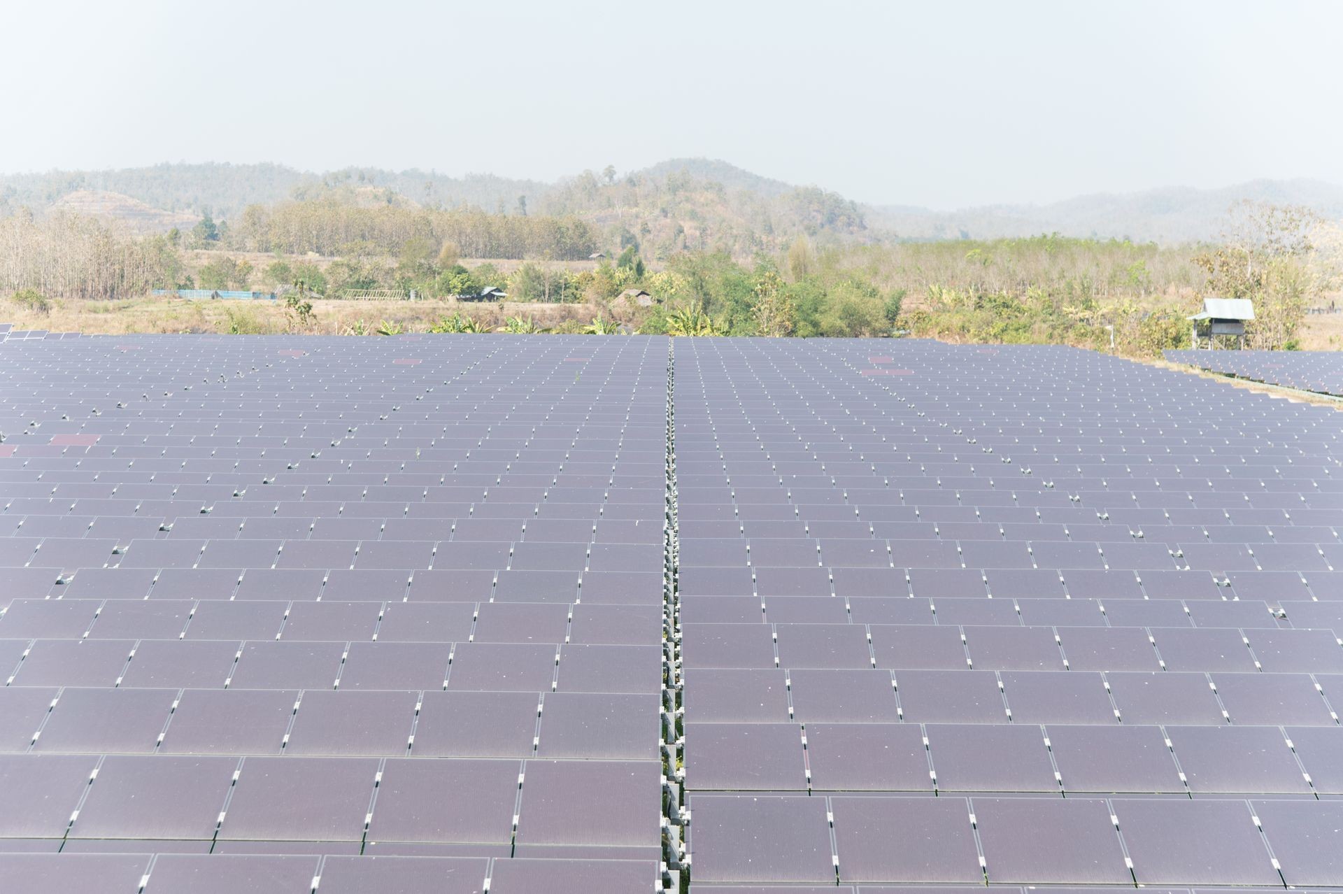 View of solar farm in sunlight with blue sky, dirty solar cell  array, green energy concept.