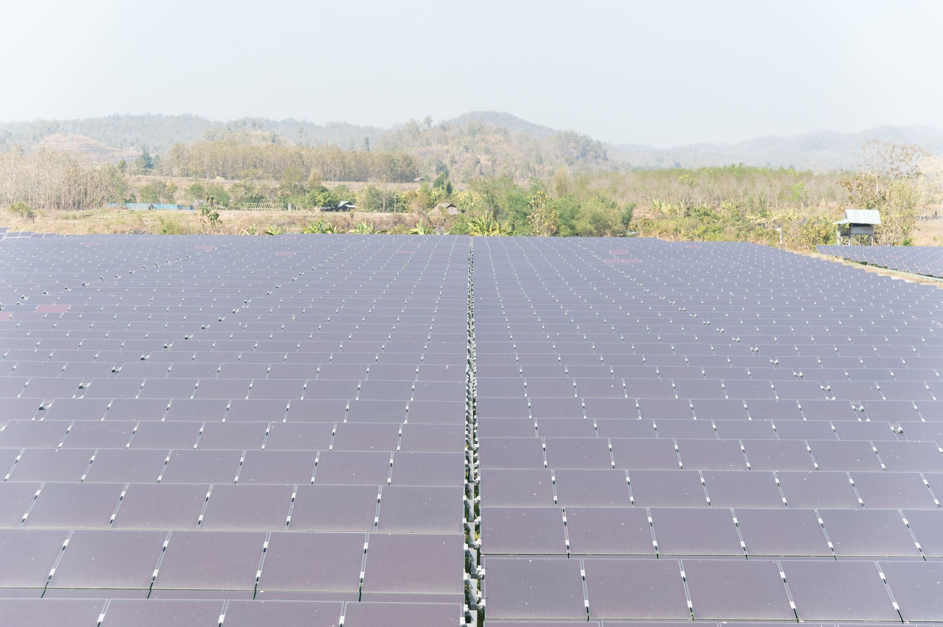 View of solar farm in sunlight with blue sky, dirty solar cell array, green energy concept.